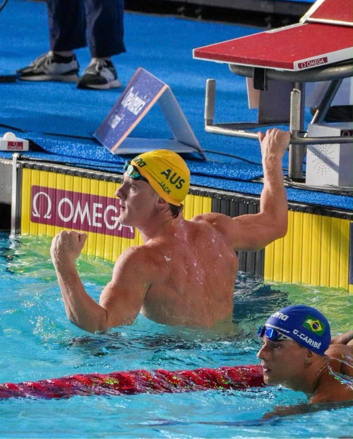 Jamie Jack Agency X Talent — arm raised to the scoreboard after his Pan Pacific gold
