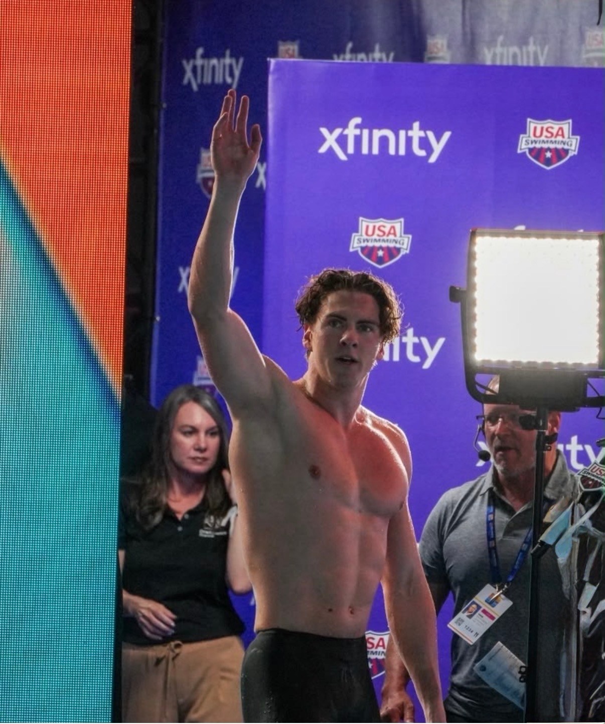 Jamie Jack Agency X Talent — celebrating on deck at the 2026 Pan Pacific Championships in Irvine, USA Swimming branding behind him